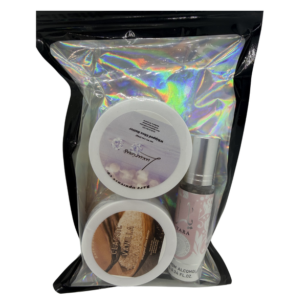 A black zip lock style package containing two sample sized shea butters in the scents Luxurious and Classic Vanilla. Accompanies by a pink yara fragrance roller. 
